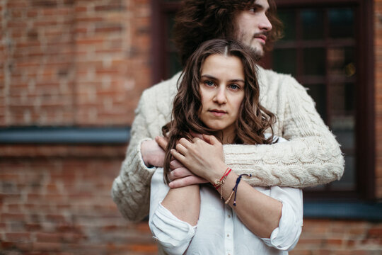 Young loving couple hagging on the walk in city.