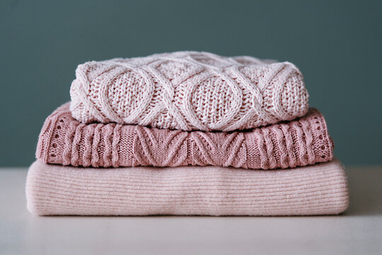 A stack of knitted sweaters.