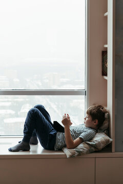 A little boy looks at the game tablet.