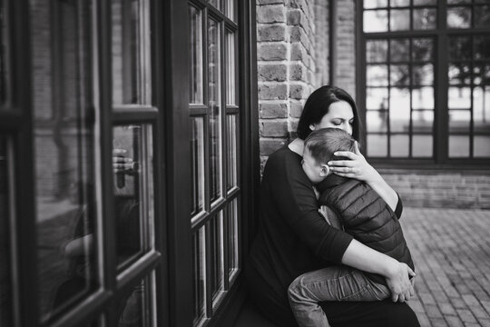 Black and white portrait of a mother with a little son.