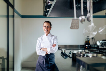 Positive female chef in restaurant kitchen