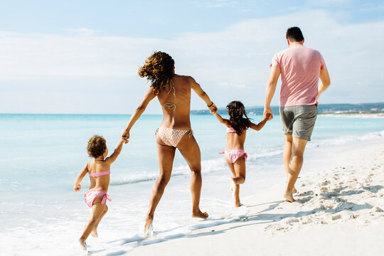 Multiracial family having fun on beach