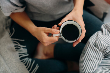 Crop woman drinking strong coffee