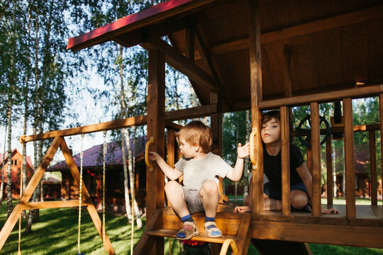 Little brothers are bored outdoor.