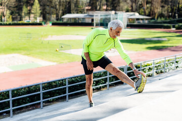 Senior sportsman warming up during training