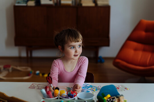 Cheerful kid playing educational game at home