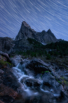 Startrail over mystic mountain range