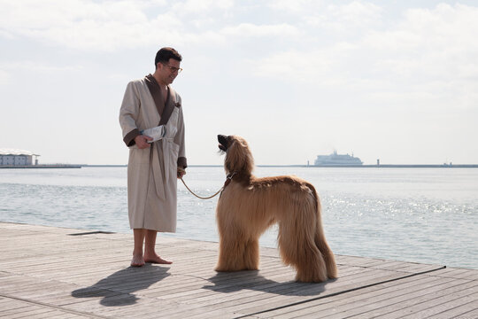 Portrait of man walking the Afghan dogs