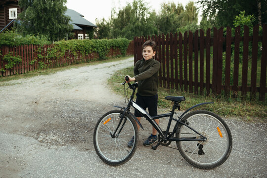 A young boy with a bicycle.