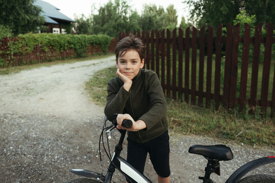 A young boy with a bicycle.