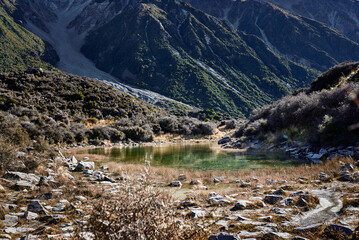 Green lagoon surrounded by mountains and rocks