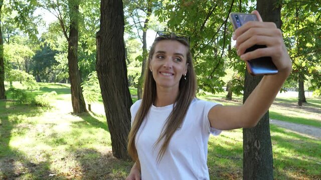 the girl is filmed on the phone for tik-tok and other social networks video content in which she makes, an emulation of a long walk from which she is tired