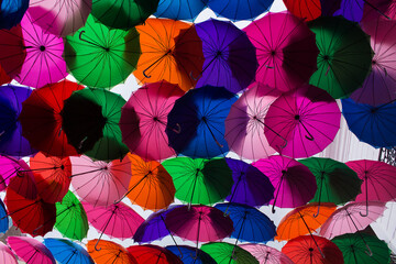 Fototapeta na wymiar Detail of colorful umbrellas in the streets