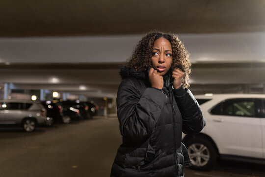 African-american woman fearful in parking structure