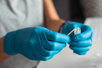 Process of coronavirus testing examination at home, COVID-19 swab collection kit, test tube for taking OP NP patient specimen sample, testing carried out, patient receiving a corona test