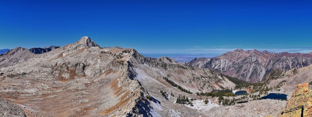 Fototapeta premium View of Pfeifferhorn peak and Lone Peak Wilderness mountain landscape from White Baldy and Pfeifferhorn trail, towards Salt Lake Valley, Wasatch Rocky mountain range, Utah, United States. 