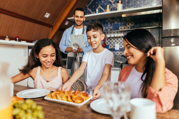 Latin family eating healthy breakfast in the kitchen