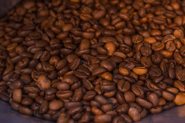 scattering of brown coffee beans, background and texture