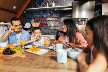 Latin family eating healthy breakfast in the kitchen