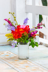 glass pot used as a vase with various flowers