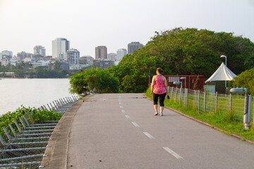 woman walking at rodrigo de freitas lagoon in Rio de Janeiro, Brazil