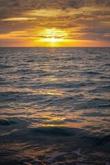 Brilliant sunset over the ocean waves reflecting on the water at Sanibel Beach in Florida before Hurricane Ian