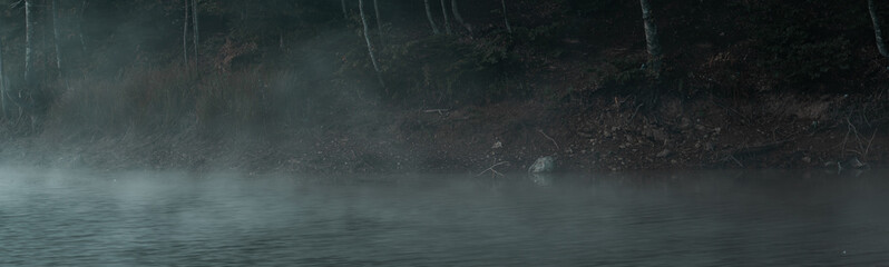 Mysterious foggy scene on the lake. Bozcaarmut lake in Bilecik Turkey in the autumn early morning. Panoramic view.