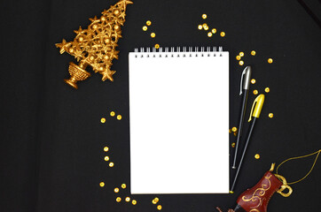 gold shiny christmas toys and golden decorations festive confetti , greeting card, mock up, copy space, white sheet of paper, xmas theme