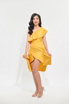 beautiful asian women swirling with happiness, in pretty yellow dress