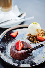 Chocolate fondant (cupcake) with strawberries and ice cream
