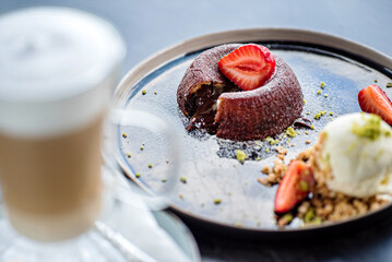 Chocolate fondant (cupcake) with strawberries and ice cream