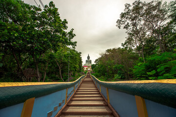 The background of a bridge or a walkway to admire the mountain scenery resembles a Phaya Naga mortgage statue, (Wat Phra Bat Phu Pan Kham) in Khon Kaen Province, Thailand.