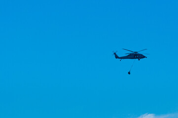 helicopter in flight with bringing some package in Dili Timor Leste
