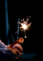 toddler hand hold sparkler fireworks