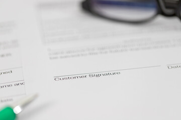 Sign on contract document with fountain pen and glasses