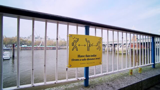 Coronavirus Covid-19 information sign encouraging social distancing in Central London at South Bank, showing people having to obey 2m social distance rule in England, Europe