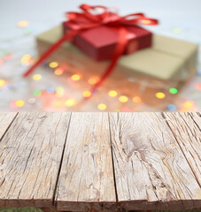 Blurred background : Gift boxes with bows on bokeh light and wood floor