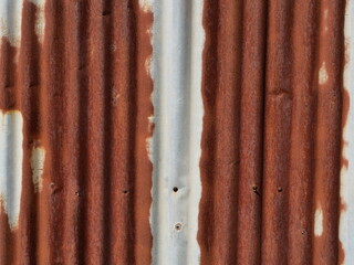 Rusty zinc sheet texture and background, Reddish brown stain on metallic silver	
