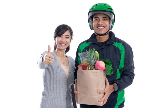 Online Grocery Shopping. Delivery Man Deliver Food Order To Customer Isolated Over White Background