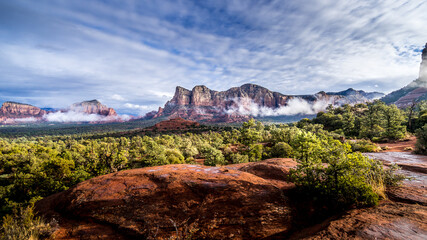 Low Cloud hanging around the Red Rocks of Munds Mountain after a heavy rainfall near the town of Sedona in northern Arizona in Coconino National Forest, USA