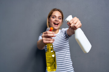 Woman striped t-shirt detergent cleaning housework gray background