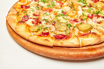 Fresh pizza pickles, bacon, sausages and cheese on a wooden board. Close-up, selective focus