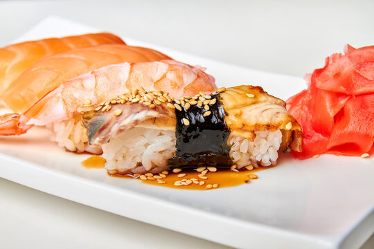 Nigiri Sushi With Smoked Eel, Unagi Sauce And Roasted Sesame Seeds. Close-up, Selective Focus