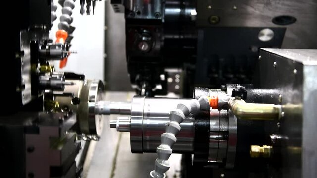 The multi-tasking CNC lathe machine hi-technology metal working process with turning machine control by computer program at industrial