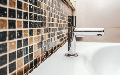modern chrome faucet on white basin