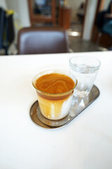 Close up glass of Latte coffee with iced water