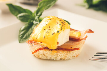 Plate with tasty egg Benedict on table, closeup