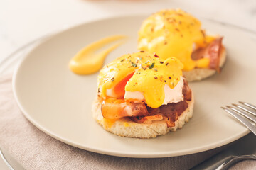 Plate with tasty eggs Benedict on table, closeup