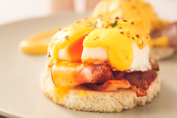 Tasty egg Benedict on plate, closeup