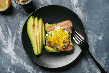 Plate with tasty egg Benedict on table